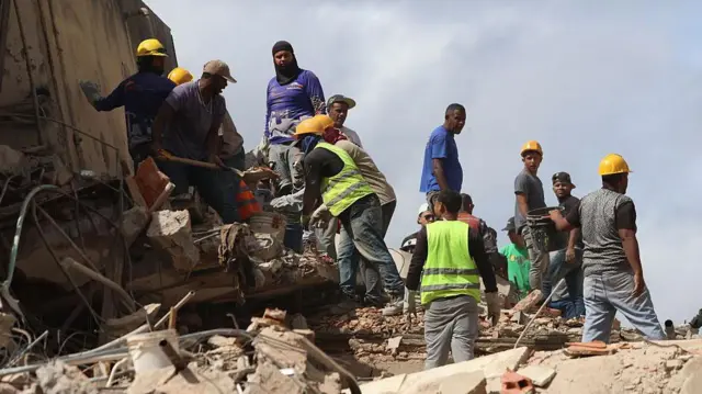 Trabajadores retiran escombros durante las operaciones de búsqueda y rescate en Venezuela